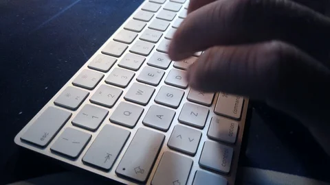 Employee writes with pc keyboard Stock Footage 113387143
