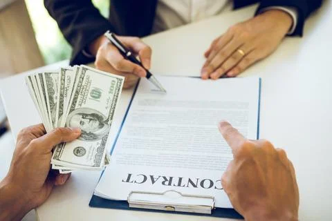 Employees are doing corruption by giving dirty money to signing contract. Stock Photos
