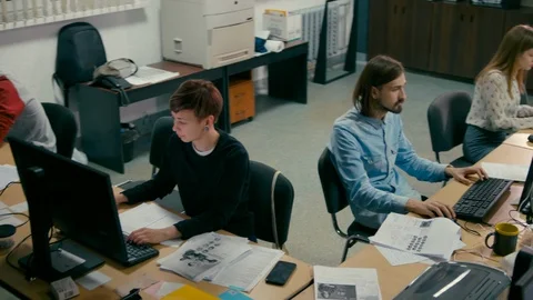 Employees are Working in the Open Space Office at Common Desk with Computers Stock Footage