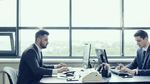 Employees of company work in spacious bright office behind computer monitors.  Stock Footage 92733603