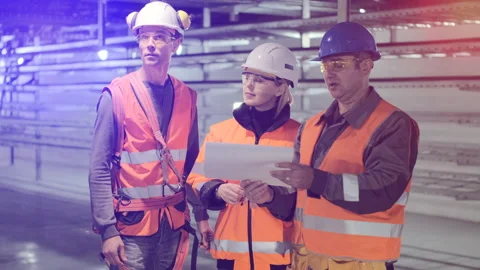 Employees discuss checking new electrical station equipment Stock Footage 143960037