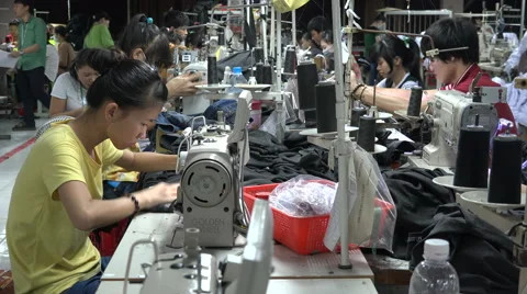 Employees of a garment factory work on production line in Saigon, Vietnam Stock Footage