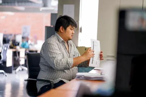 Employees man are preparing documents in the office. With Binding Machine Stock Photos