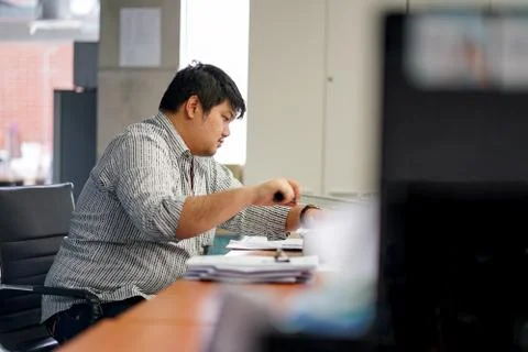 Employees man are preparing documents in the office. With Binding Machine Stock Photos