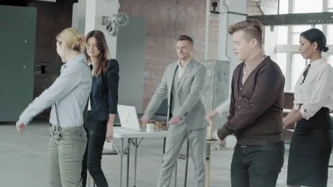 Employees in the office learn to dance together. Business colleagues have fun Stock Footage 124330132