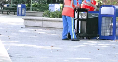 Employees remove trash from trash cans into a large trash bag in Paris on Au 스톡 동영상 344443824
