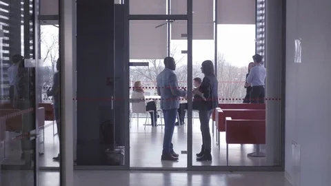 Employees spending their pause with partners in the office breakout area Stock Footage 75574145