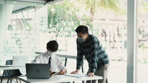 Employees submit documents at their office while wearing masks during the out 스톡 동영상 154392954