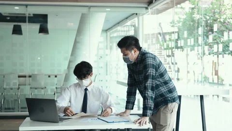 Employees submit documents at their office while wearing masks during the out 스톡 동영상 158668850