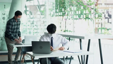 Employees submit documents at their office while wearing masks during the out 스톡 동영상 161221832