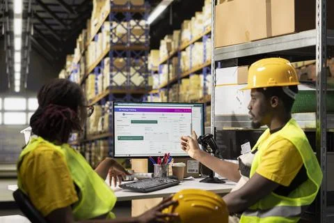 Employees team checking parcel status on a package tracking software Stock Photos