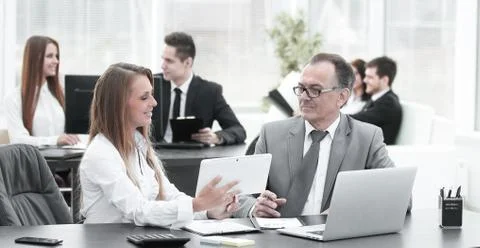 Employees using digital tablet to work with financial data Stock Photos