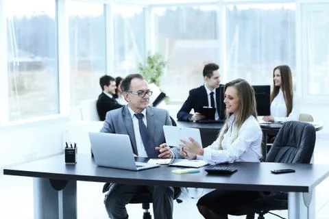 Employees using digital tablet to work with financial data Stock Photos