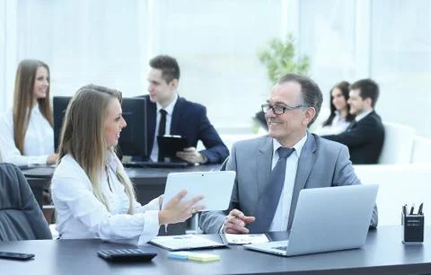 Employees using digital tablet to work with financial data Stock Photos