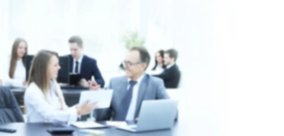 Employees using digital tablet to work with financial data in blur Stock Photos