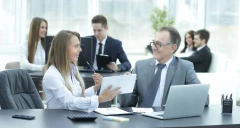 Employees using digital tablet to work with financial data Stock Photos