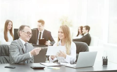 Employees using digital tablet to work with financial data Stock Photos
