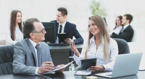 Employees using digital tablet to work with financial data Stock Photos