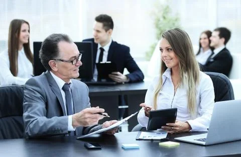 Employees using digital tablet to work with financial data Stock Photos