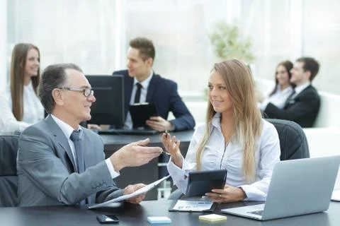 Employees using digital tablet to work with financial data Stock Photos