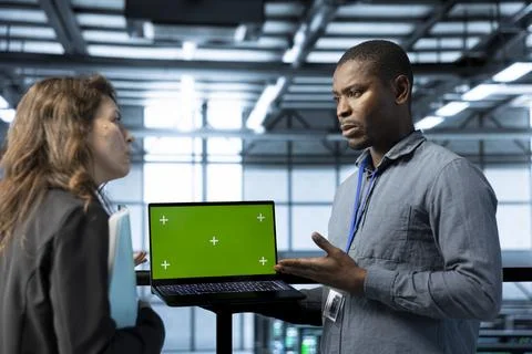 Employees using isolated screen notebook to configure server cluster nodes Stock Photos