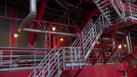 Employees walk down a ladder onto the deck of an offshore oil platform. Stock Footage 263059474