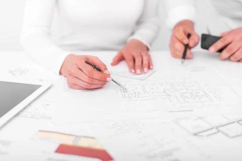 Employees work on blueprints or engineering plans in the office. Engineering. Stock Photos