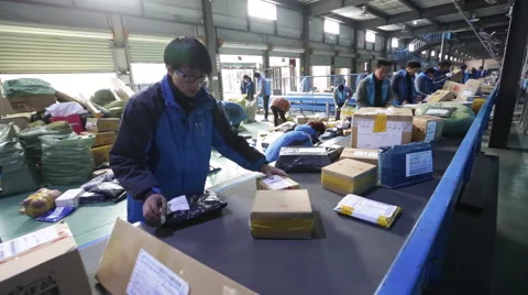 Employees work at the sorting centre of an express company Stock Footage 56757271