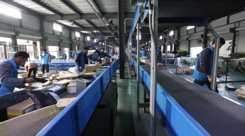 Employees work at the sorting centre of an express company Stock Footage 56759398