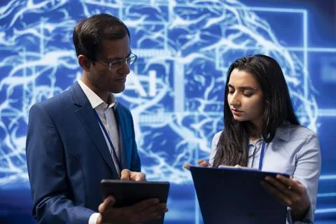 Employees at work using artificial intelligence technology, checking parameters 写真素材