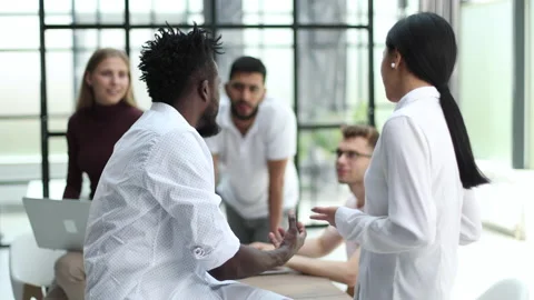Employees working at computer together, discussing content. Intern learning new Stock Footage 223239012