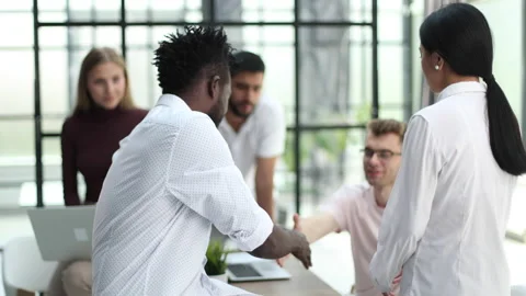 Employees working at computer together, discussing content. Intern learning new Stock Footage 233137902