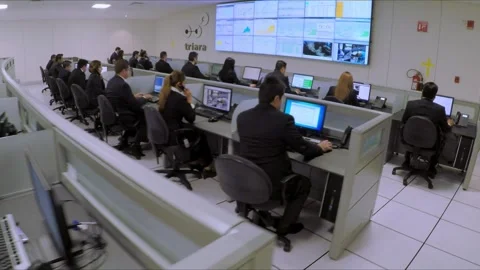 Employees Working At Computer Workstations Inside Modern Security Operations Stock Footage 348794285