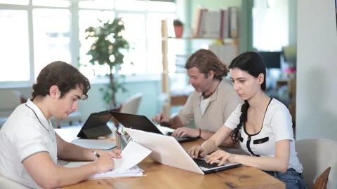 Employees working with laptops and paper documents in office Stock Footage 341534752