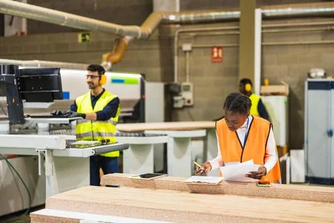 Employees working in a modern timber processing factory Stock Photos
