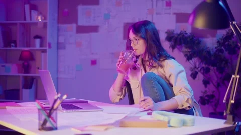 Empowered Learning, Gen Z Style. Student Looks at Camera in Neon Light Stock Footage 306887779