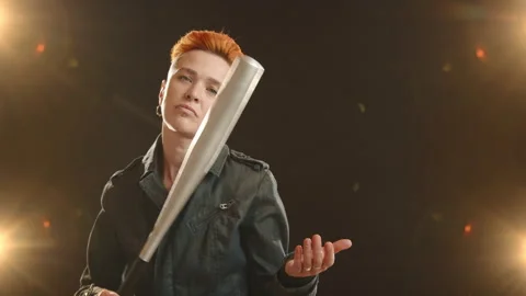 Empowered Lesbian with Bat and Determined Gaze in a Defiant Stance Stock Footage 263461650