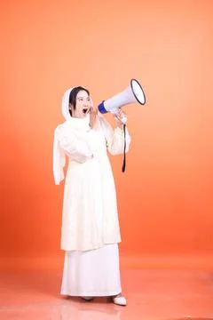 Empowered muslim lady using a megaphone to amplify her message, Stock Photos