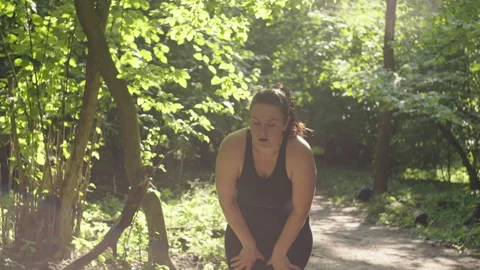 Empowering Outdoor Workout: Plus-Size Woman Running in Nature Stock Footage 248621789