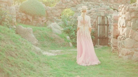 Empress with a gorgeous crown and light tress gracefully and gently steps in a Video stock 100407401