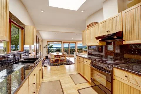 Empressive kitchen interior with shiny black granite tops Stock Photos