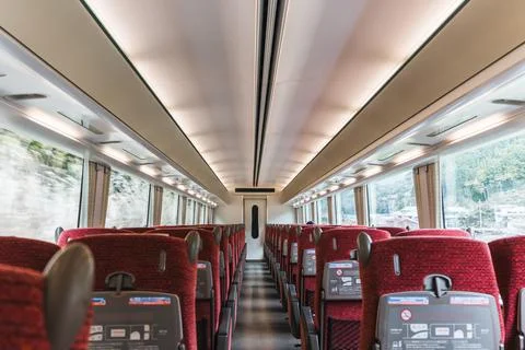 Emptry train cabin with rows of seats and large scenic windows during the tri Stock Photos