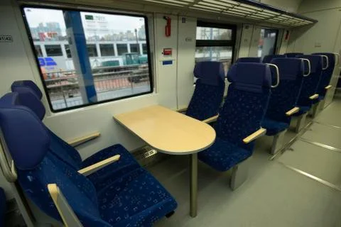 Empty 2 class compartment of wagon of commuter train, seats and doors Stock Photos