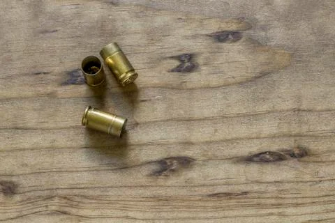 Empty 9mm Ammunition Shell Casings on Wooden Table Stock Photos
