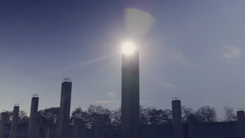 Empty, abandoned construction site with concrete pillars, sun flare. Stock Footage 142674134