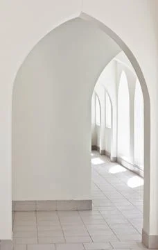 Empty abstract light interior corridor background with arches and sunlight Stock Photos