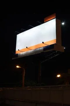 Empty advertisement billboard with white blank space background at night abov Stock Photos