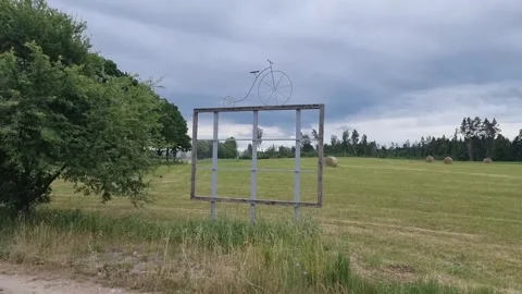 An empty advertising banner with an old-time bicycle sculpture. Video stock 303563265