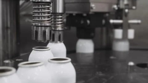 Empty aerosol cans move along the conveyor belt of the filling plant. Stock Footage 306575849