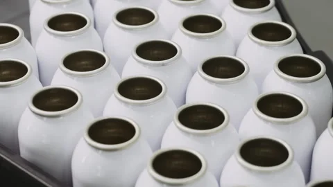 Empty aerosol cans move along the conveyor belt of the filling plant. Stock Footage 306576543